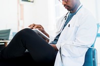 Male provider looking at tablet