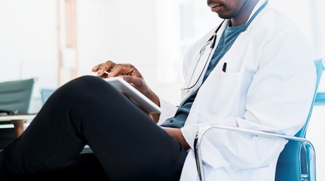 Male provider looking at tablet
