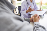 Sitting at a desk with a patient