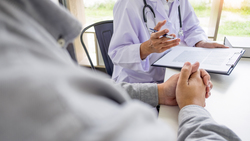 Sitting at a desk with a patient